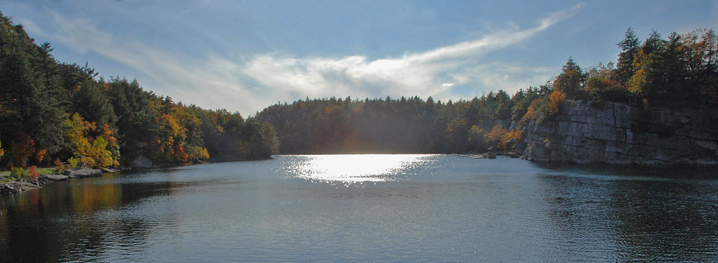 A scenic photograph of a lake surrounded by dense forest
